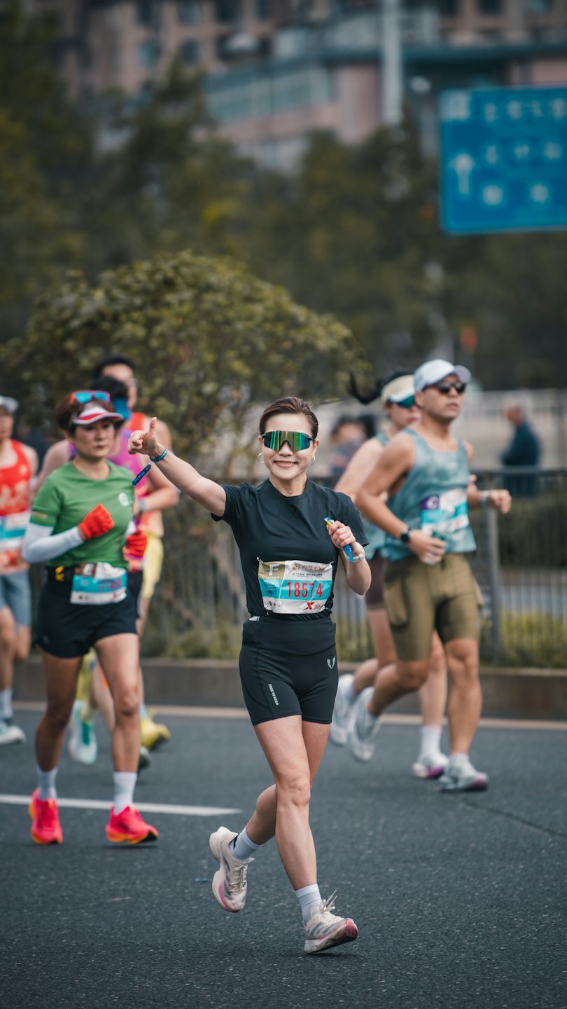 Runner gives a thumbs-up while holding an energy gel.